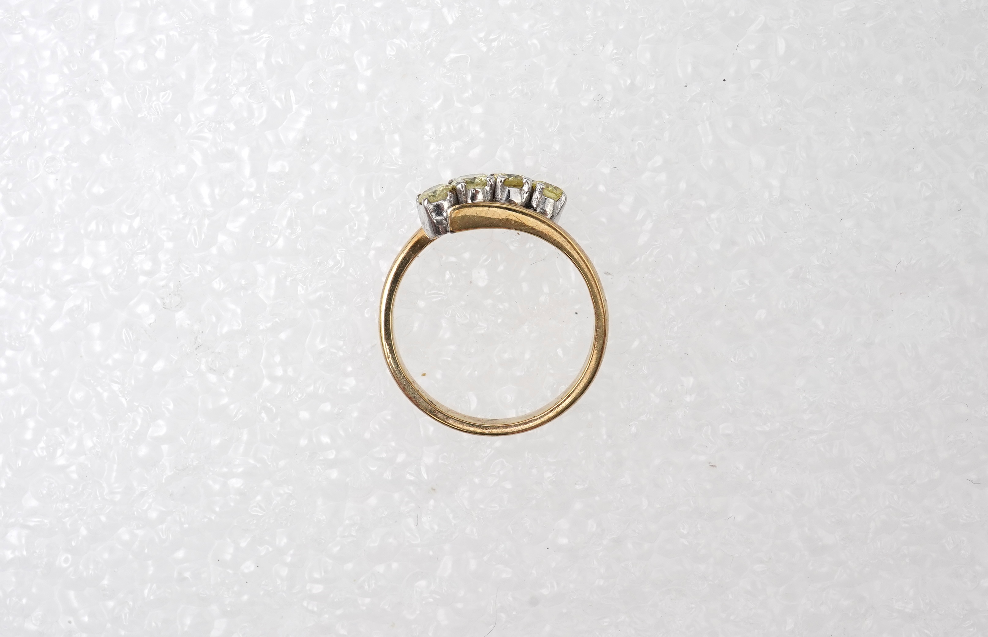 A yellow diamond ring, claw-set with four brilliant-cut diamonds of yellow tint totalling approximately 0.40 carats, mounted in gold, gross weight approximately 2 grams